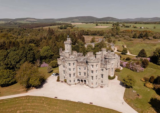 view of cluny castle from drone with surrounding land